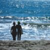Two women looking at the waves - Immaginare Press